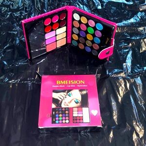 Compact makeup kit in a hot pink case